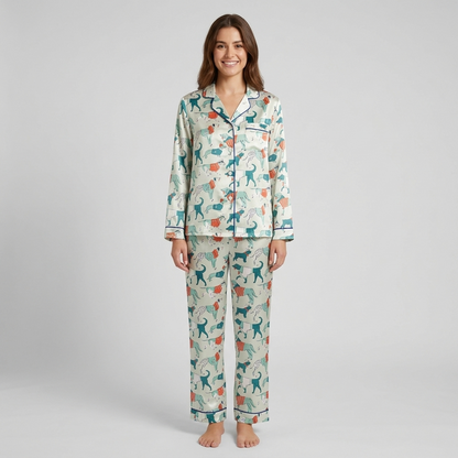 Women's satin pajama set with sleek teal dogs in coral and navy striped sweaters on soft cream - long sleeve and pants