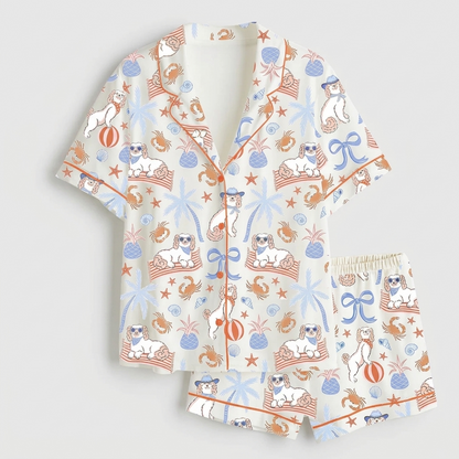 Women's satin pajama set with white pups in sunglasses with crabs, pineapples and palm trees - flat lay