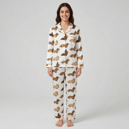 Women's satin pajama set with dachshunds dressed as ghosts, mummies and witches on creamy white with orange piping - long sleeve and pants