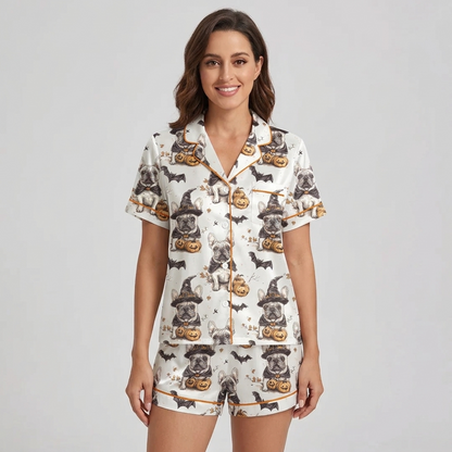 Women's satin pajama set with French bulldogs in witch hats beside jack-o'-lanterns and bats on white with orange piping - short sleeve and shorts