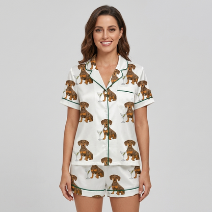 Women's satin pajama set with dachshunds beside martini glasses with olives on white with green piping - short sleeve and shorts