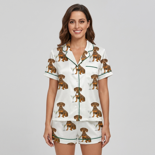 Women's satin pajama set with dachshunds beside martini glasses with olives on white with green piping - short sleeve and shorts