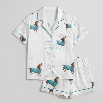 Women's satin pajama set with a Dog Parking sign and a dachshund in a teal sweater on white - flat lay