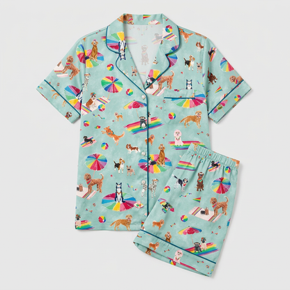 Women's satin pajama set with retrievers and beagles on rainbow beach umbrellas on seafoam green - flat lay