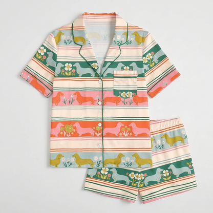 Women's satin pajama set with dachshunds in a Fair Isle style print of cream, orange, mint and pink - flat lay