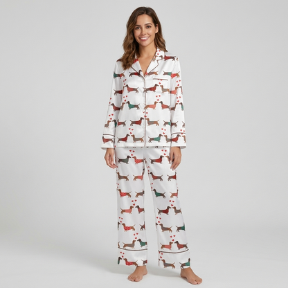 Women's satin pajama set with dachshunds in red, green and teal sweaters among tiny hearts on white - long sleeve and pants