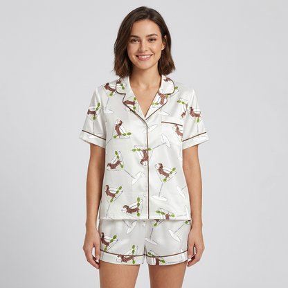 Women's satin pajama set with dachshunds stretched across martini glasses and olive picks on white with brown piping - short sleeve and shorts