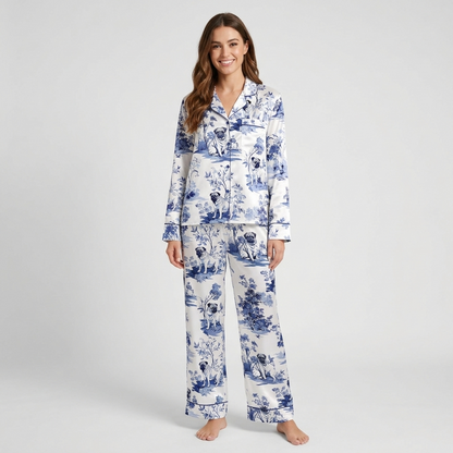 Women's satin pajama set with pugs among deep blue flowers and trees in a classic toile pattern on white - long sleeve and pants
