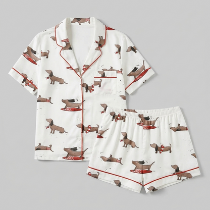 Women's satin pajama set with dachshunds on red surfboards and swim rings on white - flat lay