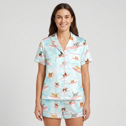Women's satin pajama set with dalmatians and terriers surfing on pink boards on watercolor blue - short sleeve and shorts