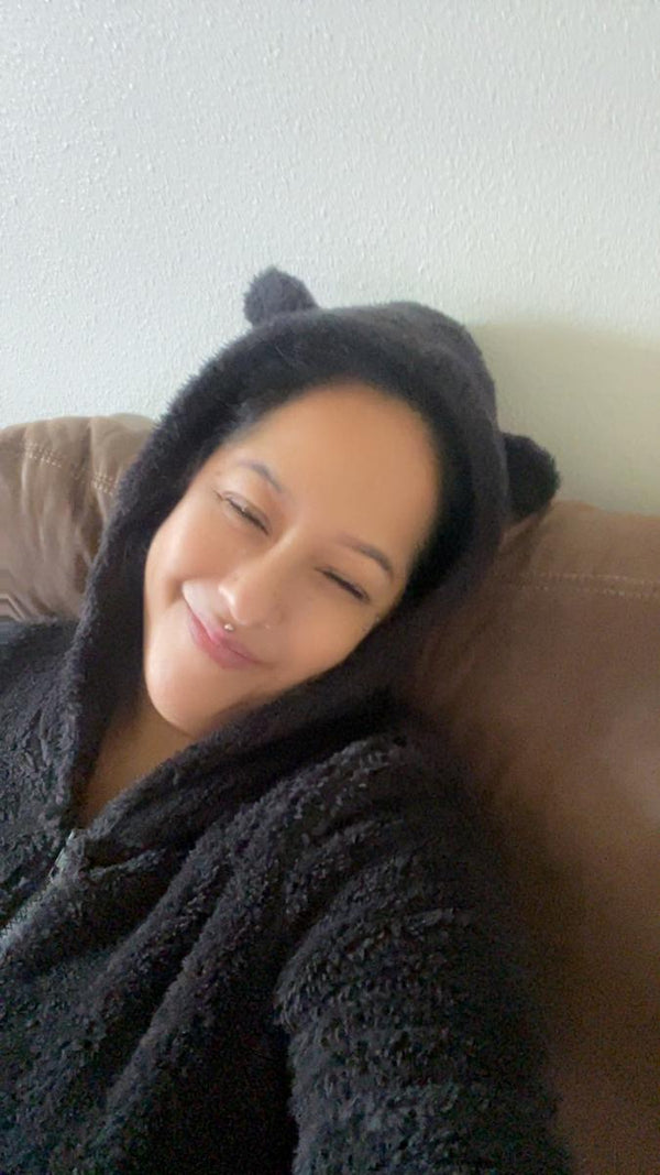 Traci G. wearing the fuzzy onesie